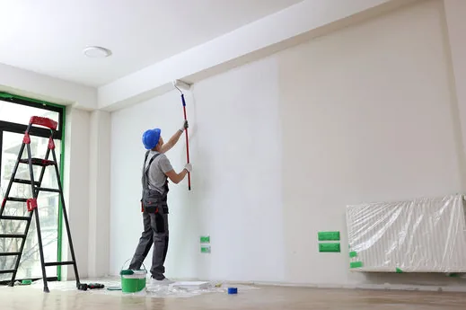 Painter rolling a bright office wall in a Valencia business park